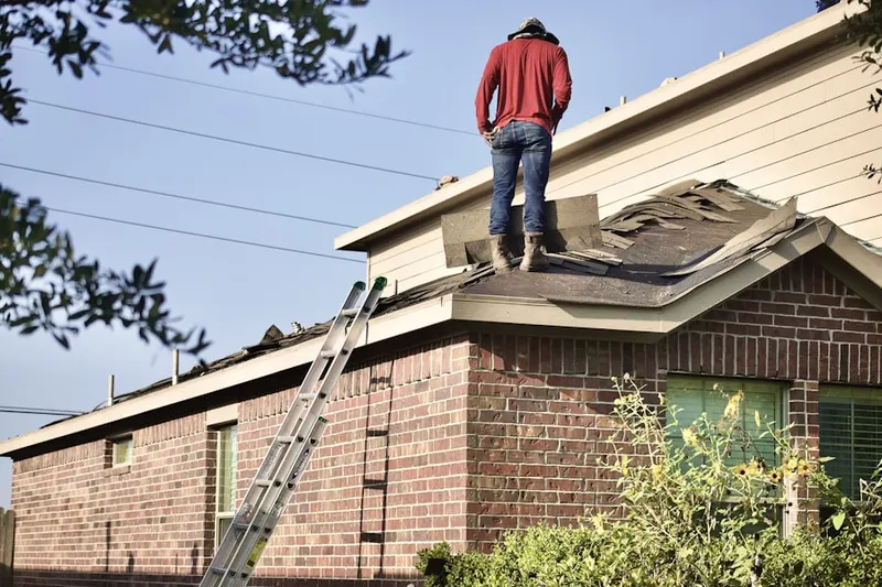 Professional roofer working on a residential roof in Highland City